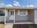 Inviting front porch features freshly painted details and updated hardware at 4739 Elkmont Rd, Orlando, FL 32808