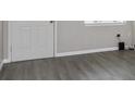 Bright living room with modern gray flooring and fresh paint at 4739 Elkmont Rd, Orlando, FL 32808