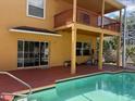 Back of home with pool, balcony, and patio on a sunny day at 508 Royal Tree Ln, Oviedo, FL 32765