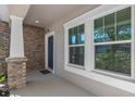 Welcoming front porch featuring brick accents, a cozy entrance, and windows at 540 Seven Oaks Blvd, Winter Springs, FL 32708