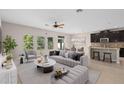 Open-concept living area featuring stylish furniture and an adjacent modern kitchen at 540 Seven Oaks Blvd, Winter Springs, FL 32708
