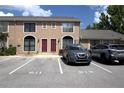 Exterior of the townhouse with parking spaces showing numbers, a light colored exterior, and a view of two stories at 613 Casa Park Court B N Ct # B, Winter Springs, FL 32708