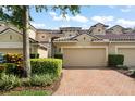 Home with brick driveway, neutral color scheme, and manicured shrubbery at 8539 Via Bella Notte, Orlando, FL 32836