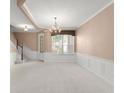 Living room with a chandelier, staircase, carpet, and lots of natural light at 8539 Via Bella Notte, Orlando, FL 32836