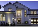 Beautiful two-story home with black-trimmed windows, modern lighting and inviting front entrance at 9155 Sheen Sound St, Orlando, FL 32836