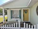 The exterior features a colorful door with a sun decoration on the facade at 1040 N Clayton St, Mount Dora, FL 32757
