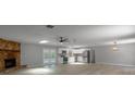 Open-concept living area with a fireplace, modern lighting, and access to the pool area at 131 Lake Charles Rd, Deland, FL 32724