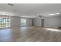 Bright and airy living area with large windows, modern light fixture and neutral decor at 131 Lake Charles Rd, Deland, FL 32724