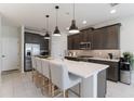 Modern kitchen with stainless steel appliances, a large island, and pendant lighting at 13748 Werrington Dr, Winter Garden, FL 34787