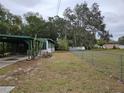 Property featuring a chain link fence and mature trees, offering privacy at 1424 Lake Shore Dr, Casselberry, FL 32707