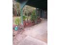 Spacious carport with room for parking and complemented by verdant greenery for curb appeal at 1424 Lake Shore Dr, Casselberry, FL 32707