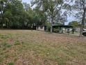 The full backyard showcasing ample space and mature trees offering privacy and shade at 1424 Lake Shore Dr, Casselberry, FL 32707