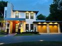 Contemporary two-story home boasts striking stone accents and a three-car garage at 1831 Mizell Ave, Winter Park, FL 32789