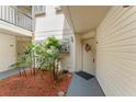 Welcoming entrance with decorative wreath, lush greenery, and charming curb appeal at 1956 Lake Atriums Cir # 146, Orlando, FL 32839