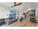 Open concept living space with hardwood floors and cozy furnishings creating an inviting atmosphere at 1956 Lake Atriums Cir # 146, Orlando, FL 32839