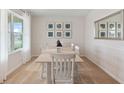 Comfortable dining room with large windows and natural light, a table with six chairs, and modern artwork at 2155 Kalin Way, Tavares, FL 32778