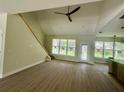 Bright living room featuring wood flooring, modern ceiling fan and multiple windows allowing natural light at 335 Ruth Blvd, Longwood, FL 32750
