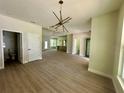Spacious living room showcasing modern light fixture, wood flooring, and ample natural light at 335 Ruth Blvd, Longwood, FL 32750