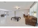 Expansive living room with tile floors, a ceiling fan, and bright, natural lighting from the window at 3629 Vega Creek Dr, St Cloud, FL 34772