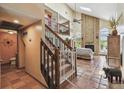 Spacious living room with a soaring ceiling, brick fireplace, and staircase to the upper level at 383 Brushwood Ln, Winter Springs, FL 32708