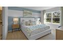 Stylish bedroom showcasing a comfortable bed, neutral decor, and abundant natural light at 3896 Diving Dove Ln, Bartow, FL 33830