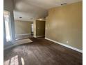 Open living room with neutral walls and carpet, showcasing the bright, airy floor plan at 410 Horizon Dr, Winter Springs, FL 32708