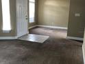 Cozy living room featuring neutral walls, carpeting, and a tiled entrance, bathed in natural light at 410 Horizon Dr, Winter Springs, FL 32708