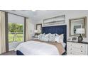 Comfortable bedroom with large window, neutral walls, stylish decor, and lots of natural light at 5113 Forget Me Not Ave, Lake Hamilton, FL 33851