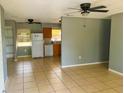 Open-concept living area with tile flooring seamlessly connecting to the kitchen at 606 E Central Ave, Eagle Lake, FL 33839
