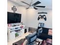 Cozy game room features a mounted flat-screen TV, comfortable seating, and decor that invites fun and entertainment at 6216 Beaumont Ave, Orlando, FL 32808