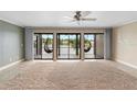 Spacious living room with large sliding doors opening to a balcony overlooking the water at 652 Lake Villas Dr # D, Altamonte Springs, FL 32701