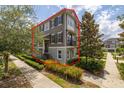 Charming townhome with a landscaped front yard and a balcony, showcasing its inviting curb appeal at 704 Grado Pt, Oviedo, FL 32765