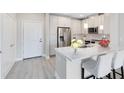 Modern kitchen features stainless steel appliances, granite countertops, and a breakfast bar with seating at 7565 Laureate Blvd # 3408, Orlando, FL 32827
