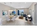 Bright living room features comfortable seating, a ceiling fan, access to a balcony, and luxury vinyl floors at 7565 Laureate Blvd # 3408, Orlando, FL 32827