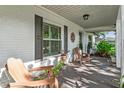 Inviting front porch featuring seating and painted brick exterior at 819 E Harbour Ct, Ocoee, FL 34761