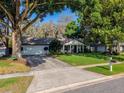 Well maintained single-story home with lush landscaping, a driveway, and charming curb appeal at 819 E Harbour Ct, Ocoee, FL 34761