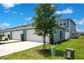 Attached two car garage with extra long driveway and some landscaping at 10940 Leafshore Loop, Orlando, FL 32829