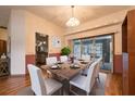 Dining room with a wooden table and chairs with sliding glass door leading to the pool at 1130 Woodchuck Ct, Orange City, FL 32763