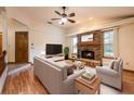 Inviting living room featuring a brick fireplace and comfortable seating area at 1130 Woodchuck Ct, Orange City, FL 32763