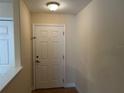 Bright and airy foyer with a classic white door, showcasing neutral walls and tile flooring at 135 Heritage Park St, Winter Springs, FL 32708