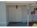 Inviting home entrance, featuring double doors, detailed trim and manicured landscaping at 1644 Cypress Woods Cir, St Cloud, FL 34772