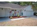 Home featuring manicured landscaping, garage and a covered entrance at 1644 Cypress Woods Cir, St Cloud, FL 34772