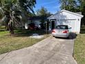 Charming home featuring a well-maintained lawn and convenient driveway parking and golf cart at 1707 E Schwartz Blvd, Lady Lake, FL 32159