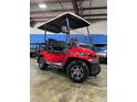 New red Advanced EV golf cart with black seats and a roof, parked inside a showroom at 1707 E Schwartz Blvd, Lady Lake, FL 32159