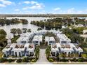 Stunning aerial view of modern townhomes near a serene lake, showcasing the community's layout at 1764 Mondrian Cir, Winter Park, FL 32789