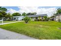 Quaint single-story home with a large front yard, mature landscaping and a welcoming neighborhood ambiance at 206 Montana Ave, St Cloud, FL 34769