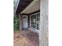 Entrance of a modest home featuring a covered porch and single door entrance at 2638 S Laurel Ave, Sanford, FL 32773
