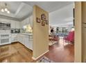 Open-concept view of kitchen and living room with wood floors and lots of natural light at 300 Carolina Ave # 304, Winter Park, FL 32789