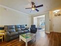 Cozy living room with hardwood floors, ceiling fan, and plenty of natural light at 430 Southern Pecan Cir # 101, Winter Garden, FL 34787
