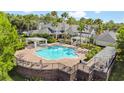 Resort-style pool with pergolas, lounge chairs, and palm trees perfect for relaxation at 430 Southern Pecan Cir # 101, Winter Garden, FL 34787